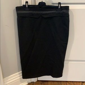 Knee length black pencil skirt. Belt like detail.